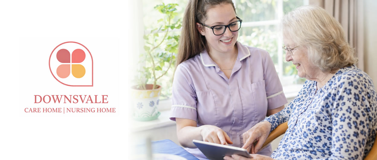 Caregiver assisting elderly woman with a tablet