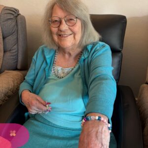 Resident concentrating while creating a beaded bracelet.