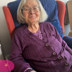 Resident proudly wearing a colorful handmade bracelet.