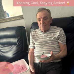 Resident smiling while enjoying a bowl of pink ice cream.