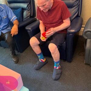 Resident concentrating while holding colourful bean bags during a game.