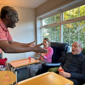 Entertainer engaging residents in a fun and interactive group session.