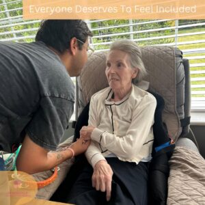 A care team member warmly engaging with a resident during a meaningful one-to-one interaction.