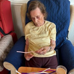 Resident taking part in a fun and engaging arts and crafts activity.