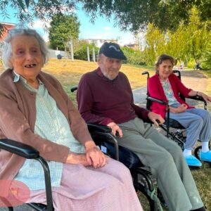 Care home residents enjoying a relaxing visit to the park.