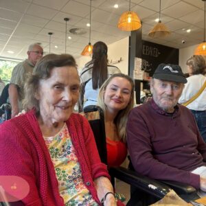 Residents and family member enjoying time together at a café.