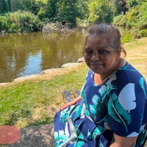 Resident smiling while enjoying a peaceful lakeside outing.