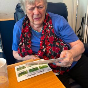 Resident reading a gardening guide.