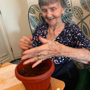 Elderly resident enjoying a gardening activity.