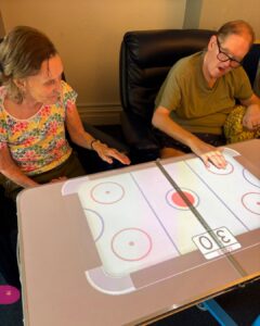 Two residents enjoy an interactive tabletop game.