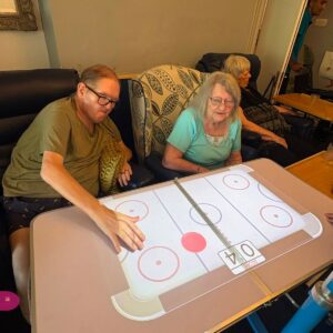 Residents play an interactive tabletop sports game.