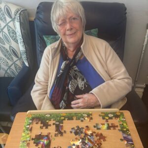 Elderly woman enjoying a jigsaw puzzle activity