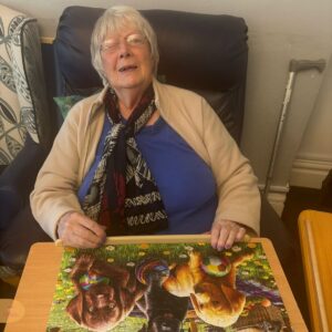 Elderly woman working on a colourful puzzle