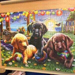 Elderly woman completing a dog-themed jigsaw puzzle