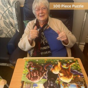 Elderly woman smiling after completing a 100-piece puzzle