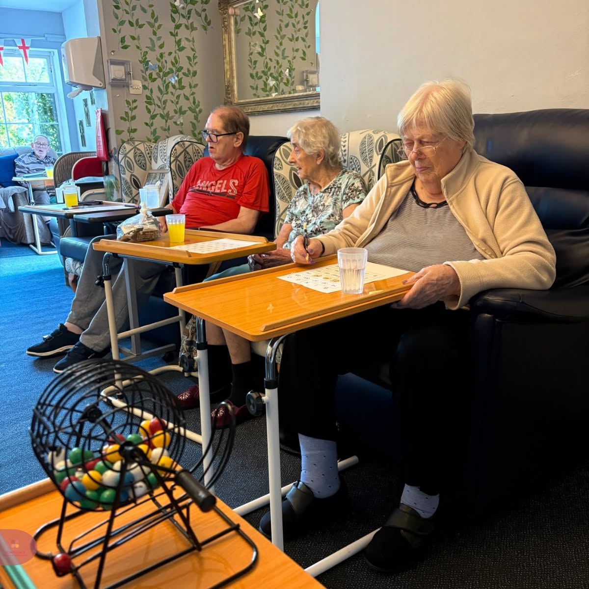 Care home residents enjoying a bingo game together.