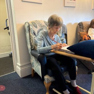 Older woman completing an activity at a care home.